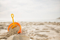 Bucket with sand and a spade on beach Free Photo