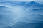 Aerial View of River Winding Through Foggy Himalyan Mountains