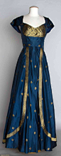 BLUE & GOLD EVENING DRESS, 1950 Blue silk taffeta w/ metallic gold brocade, fashioned from Indian sari, B 33", W 27.5", L 60", excellent.