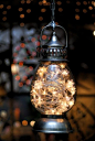Fill any inexpensive lantern with a string of white lights and hang around your yard or in a tree.: 