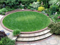 Raised circular lawn as a central garden feature.