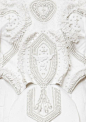 Embellished dress detail with ornate patterns & white textures; couture embroidery; close up fashion // Givenchy