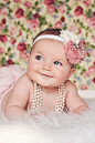 All smiles during her Vintage Floral baby photoshoot | Iliasis Muniz Photography Vintage photoshoot, floral backdrop, baby girl vintage outfits, floral baby girl headbands, pearls, pink themed photoshoot.