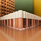 Dozens of satin glass bottles of liquid foundation in a wide variety of shades ranging from pale beige to deep ebony are arranged in random order in two rows that meet at a right angle in the center of the frame, the point extending towards the camera. Th