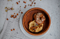 doughnut in round brown wooden tray