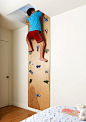 One way to program in some exercise!  Rock wall lead to a secret play space above the rooms. There is an entrance from each kid's room to the shared space.