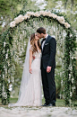 A lovely arbor with hanging flowers and a row of white rosebuds looks absolutely enchanting. Photo by Sean Money + Elizabeth Fay; Floral by Out of the Garden: 