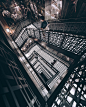 man walking on spiral staircase inside building