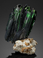 VIVIANITE  - Bolivia. When Vivianites are first brought out from the mine, they are  pretty close to colorless, but exposure to daylight causes them to  darken to a deep, transparent green with blue overtones. Old  specimens can appear almost black. Altho