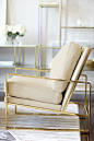 Bernhardt Interiors | Dorwin Chair, polished brass finish, shown in ivory leather | Jet Set Entertainment Piers and Console