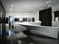 Neil Barrett Shop in Shop by Zaha Hadid Architects Black polished concrete floors + white fixtures.: 