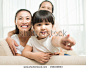 Copy-spaced portrait of a little girl pointing at something while bonding with her family on the foreground - stock photo