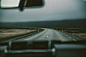 View from a car's front window on a curve in an empty road