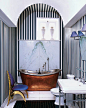 This master bath's nickel-and-brass tub is 19th century, and the chair is by Honoré Paris from Galerie Yves Gastou; the wall stripes are painted.
