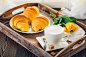 Coffee, croissant and flowers on tray on a wooden table by Kamil Zabłocki on 500px