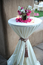 ROPE AROUND COCKTAIL TABLE. Do Black tablecloth with pink or white tie. Then Pink centerpiece on top: 