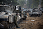 An Israeli soldier smokes a cigarette next to a convoy of tanks at an Israeli army deployment area near the Israel-Gaza Strip border as they prepare for a potential ground operation in the Palestinian coastal enclave, November 19, 2012. (Menahem Kahana/AF