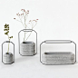Weight Vases by Decha Archjananun.  A series of vases with concrete bases to hold water and wire frames to support flower stems.