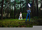 Professional wedding photographer using strobe and softbox to make pictures of the bride in the dark forest