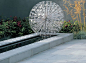 allium sculpture set above a rill - Stonemarket: Garden range: Natural Stone: Avant-Garde Paving