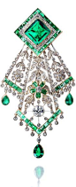 An emerald and diamond handkerchief brooch, circa 1910 The lozenge-shaped surmount set with a step-cut emerald, weighing 8.53 carats, within borders of old brilliant and single-cut diamonds and calibré-cut emeralds, suspending an openwork floral and folia