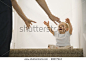 Crying baby reaching for mother - stock photo