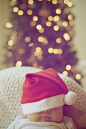 Close-up of Illuminated Christmas Tree And A Baby