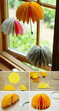 Transform paper circles to hanging umbrellas. 
