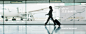 Businesswoman with suitcase in airport : Stock Photo