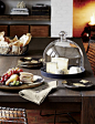 Cakes, fruit and cheese take cover on black-glazed stoneware server under a dome of clear, handcrafted glass.: 