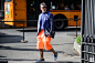 Man wearing fluorescent orange shorts at Pitti Uomo