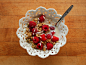 Fresh raspberries with pumpkin flax granola, flaked coconut, and almond milk.