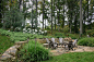 Photo of a large rustic partial sun backyard stone formal garden in Philadelphia with a fire pit.