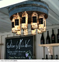 DIY Wine barrell/wine bottle chandelier WOULD be beautiful for an outside bar or "mans" cave