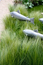 Fish sculptures in amongst the grasses  // Great Gardens & Ideas - love this look.  Wonder what I could make some out of.  (First I'd need to plant the grass...)