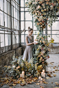 Woman Standing Beside Flowers Inside Building