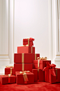 In this illustration, red boxes with ribbon on top of them, in the style of large-scale photography, elegant compositions, carpetpunk, xmaspunk, minimalist still lifes, light white and gold, lively interiors