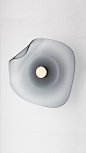 The grey version of the 'Melt' wall sconce by Articolo Architectural Lighting.