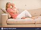 mother-holding-baby-girl-9-12-months-sitting-on-sofa-smiling-portrait-AHYWTJ.jpg (1300×956)