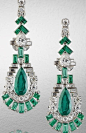 A fine pair of art deco emerald and diamond pendent earrings, circa 1920.   Each articulated geometric surmount set with baguette-cut emeralds, brilliant, pear and baguette-cut diamonds, suspending a pear-shaped emerald swing drop, within a stepped surrou
