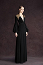 Black velvet gown with opulent layered gold beading on shoulders and modified lantern sleeves. Andrew Gn 2013.