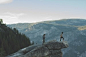 Tourists standing on rocks in mountains 