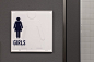 Icons are subtly etched on the backside of restroom signs.