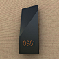  Room number with slanted fold shape. Black matte painted stainless steel finishing. 