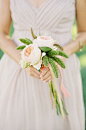 A simple and romantic wedding bouquet compliments the delicate dusty rose colored bridesmaid dress.