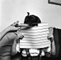 A young girl holds up a piece of cardboard to ensure that her mother cuts her fringe straight, circa 1955.
Photo by Sherman/Three Lions/Getty Images