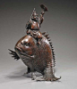 Early 20th Century Japanese Bronze DaikokuEarly 20th century, Japanese bronze model of Daikoku; seated atop a huge carp and carrying a staff in one hand, a fan in the other; L: 16"