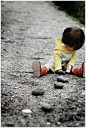 So cute and....contrasting. The little child on hard, gray rock. Bright and carefree against realistic and normal.