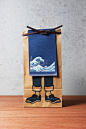 Anything : NOSIGNER designed the package of "Anything," the brand of traditional-Japanese-style aprons. The paper bag, originally used for rice, illustrated with the apron provides an actual image of how to wear it and its lineup.