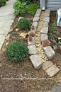 Making A Dry Creek Bed Drainage Canal for Downspouts. One of the most creative ideas I've seen for this project.: 